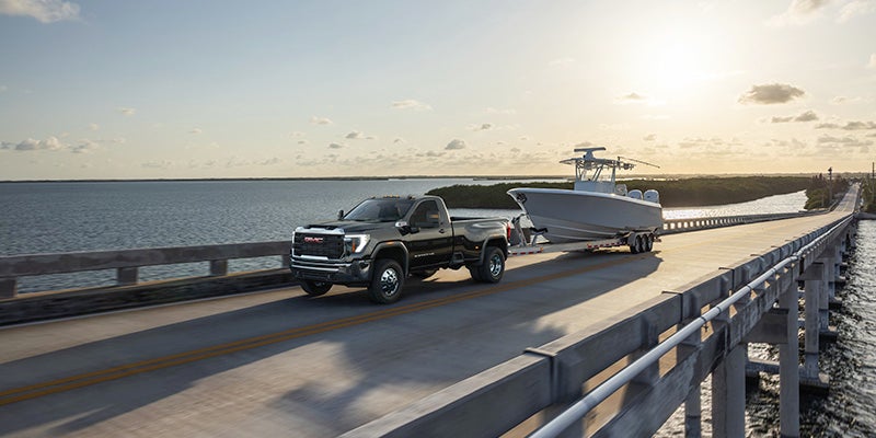 GMC Sierra HD pulling a trailer on a bridge