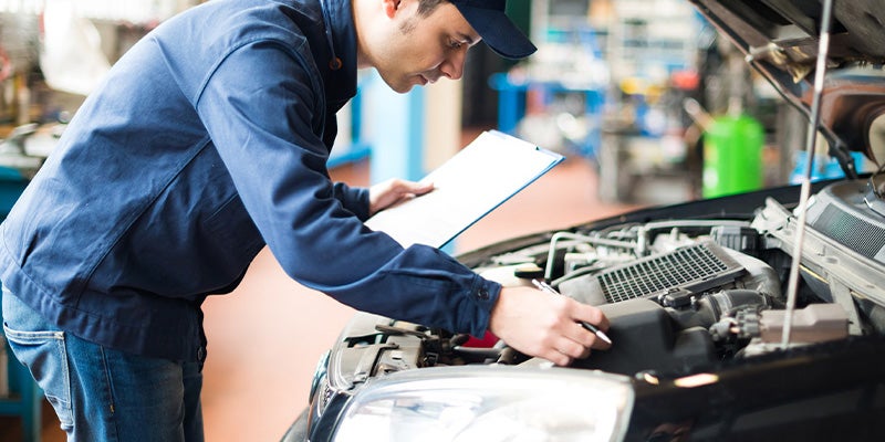 Plattner's Quincy GMC in QUINCY FL technician working on car